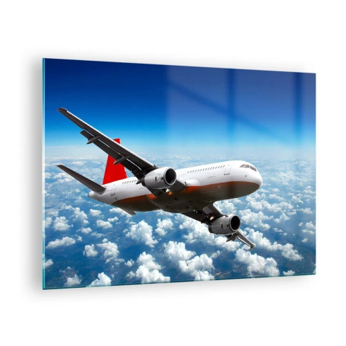 Billede på glas - Et passagerfly, der flyver over skyerne mod en blå himmel - 70x50cm - Kom væk fra det hele - Moderne vægdekoration til stue og soveværelse ARTTOR