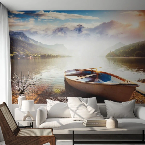 Fototapet Standard Eco - En båd på en sø omgivet af bjerge ved solnedgang - 100x70cm - Over store og klare vande - Moderne vægdekoration til stue og soveværelse ARTTOR