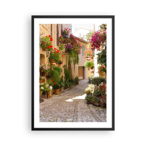 Plakat i sort ramme - En blomstrende gade med stenbelægning og blomsterpotter - 50x70cm - I en strøm af blomster - Moderne vægdekoration til stue og soveværelse ARTTOR
