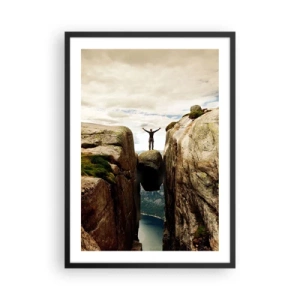 Plakat i sort ramme - En mand stående på en klippe ophængt mellem klipper - 50x70cm - Hvordan har jeg det! - Moderne vægdekoration til stue og soveværelse ARTTOR