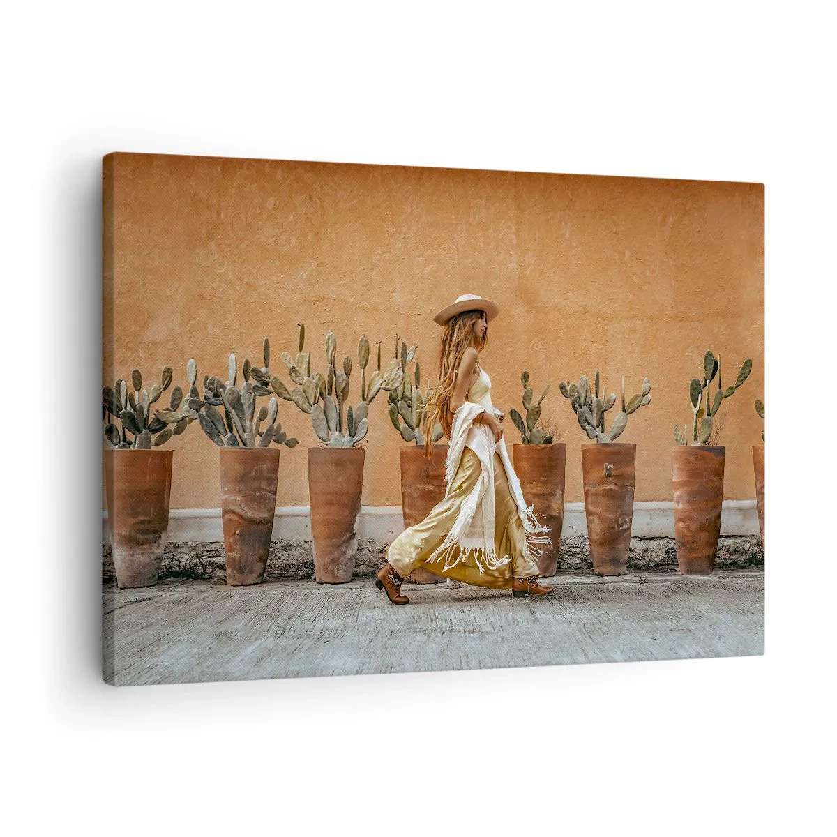 Lærredstryk - Billede på lærred - En kvinde i boho-stil med potter med kaktus i baggrunden. - 70x50cm - I en hippieagtig stil - Moderne vægdekoration til stue og soveværelse ARTTOR