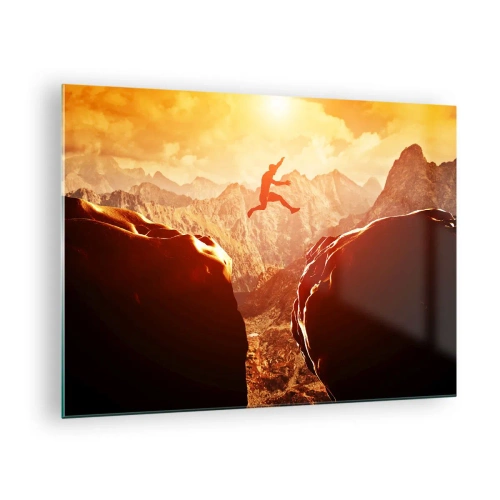 Billede på glas - Springe over en kløft i et bjerglandskab ved solnedgang - 70x50cm - Overskridelse af grænser - Moderne vægdekoration til stue og soveværelse ARTTOR