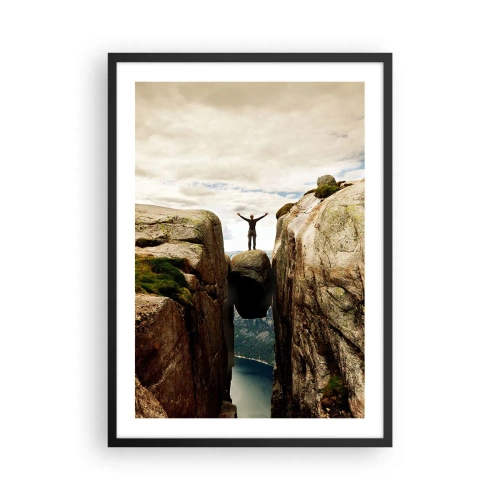 Plakat i sort ramme - En mand stående på en klippe ophængt mellem klipper - 50x70cm - Hvordan har jeg det! - Moderne vægdekoration til stue og soveværelse ARTTOR