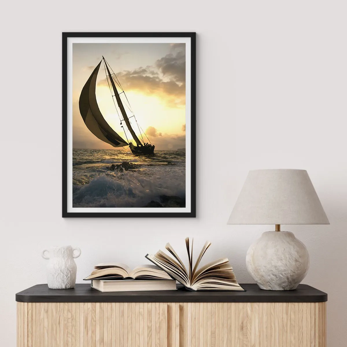 Plakat i sort ramme - En sejlbåd på et stormfuldt hav i gløden fra den nedgående sol - 50x70cm - I medvind og modvind - Moderne vægdekoration til stue og soveværelse ARTTOR