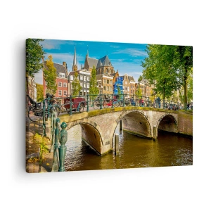 Lærredstryk - Billede på lærred - En malerisk kanal med en bro i Amsterdam - 70x50cm - Forår ved kanalen - Moderne vægdekoration til stue og soveværelse ARTTOR