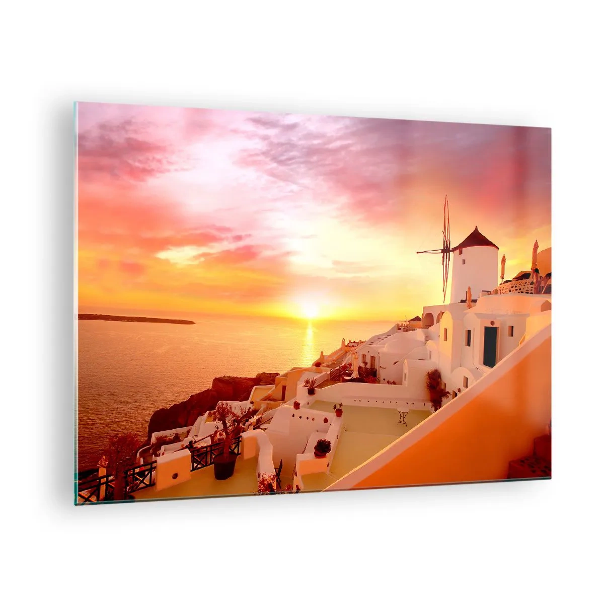 Billede på glas - Solnedgang over Santorini med hvide bygninger og en vindmølle - 70x50cm - Opløses i hvidt og guld - Moderne vægdekoration til stue og soveværelse ARTTOR