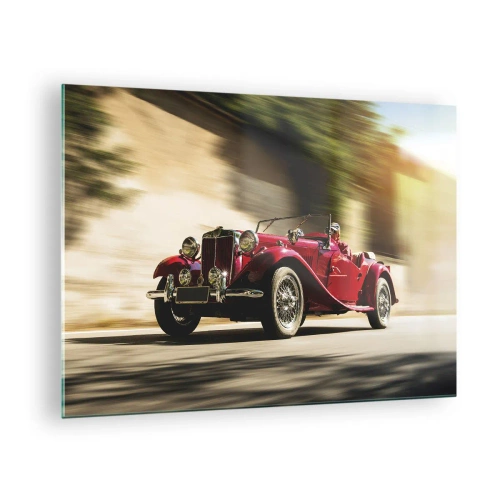 Billede på glas - Klassisk rød cabriolet i bevægelse mod baggrunden af gaden og det slørede landskab - 70x50cm - Smukkere end Nike fra Samothrake - Moderne vægdekoration til stue og soveværelse ARTTOR